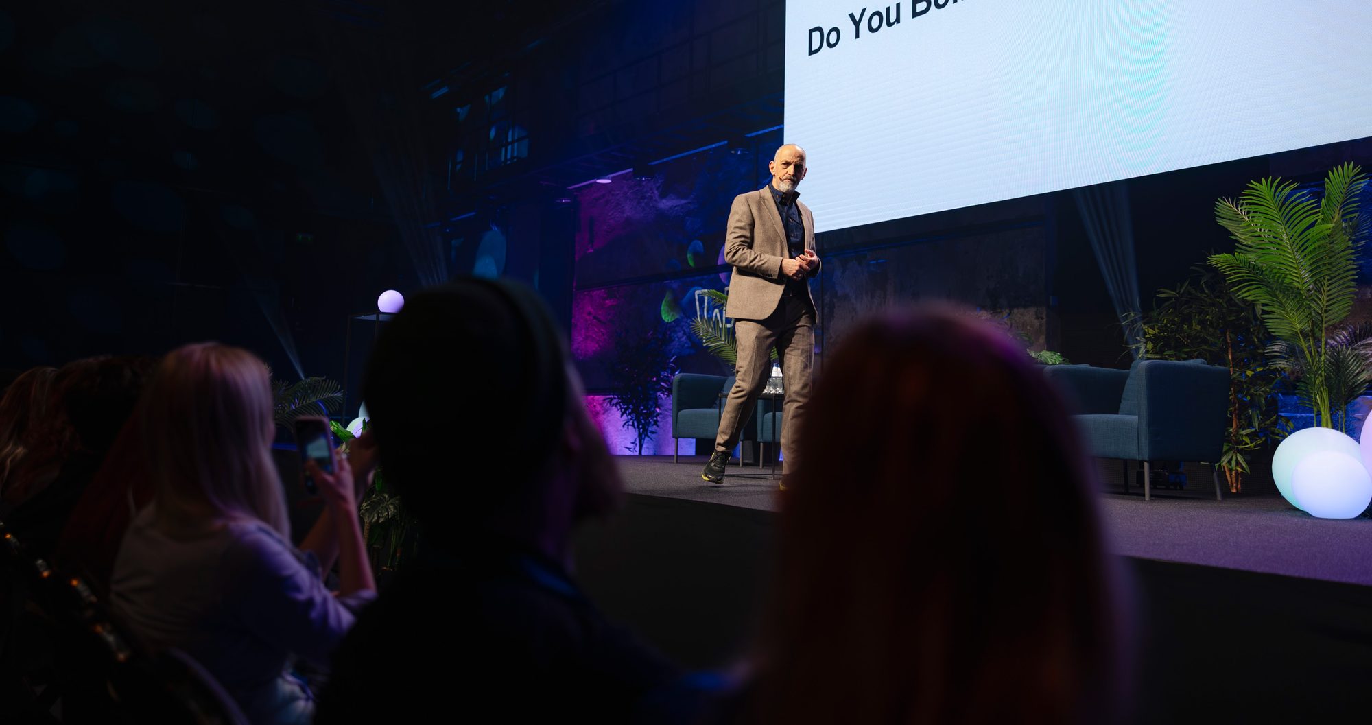 Steve Rawling speaking on stage, seen over the heads of the audience watching him.